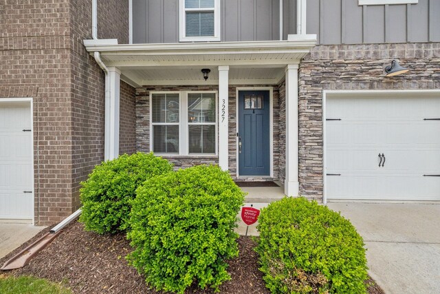 3227 Brookberry Ln, Murfreesboro, TN 37129 - entrance to property featuring board and batten siding, stone siding, concrete driveway, and covered porch