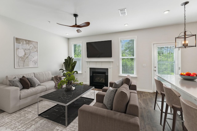 3227 Brookberry Ln, Murfreesboro, TN 37129 - living area featuring wood finished floors, a chandelier, ceiling fan, a glass covered fireplace, and baseboards