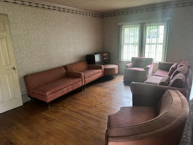 living area with wallpapered walls and hardwood / wood-style flooring