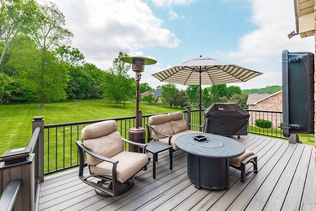 wooden terrace with a lawn and area for grilling