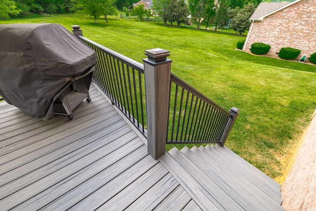 deck featuring a lawn and a grill