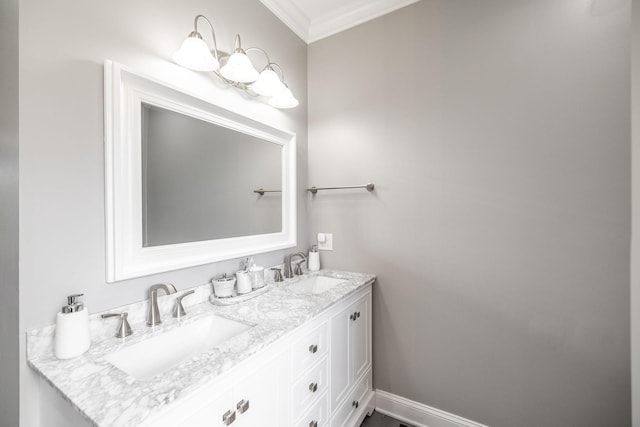 bathroom with a sink, ornamental molding, and double vanity