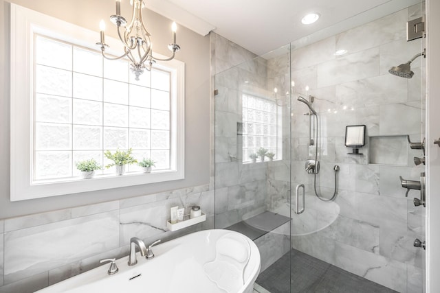 bathroom featuring a chandelier and a shower stall