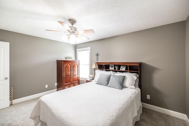 carpeted bedroom featuring baseboards and a ceiling fan