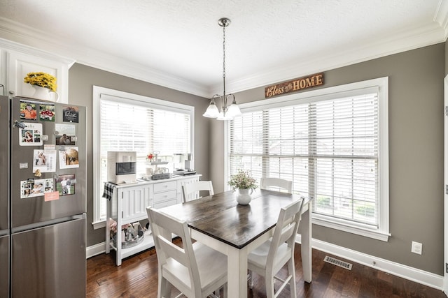 dining space with dark wood-style flooring, visible vents, baseboards, an inviting chandelier, and ornamental molding