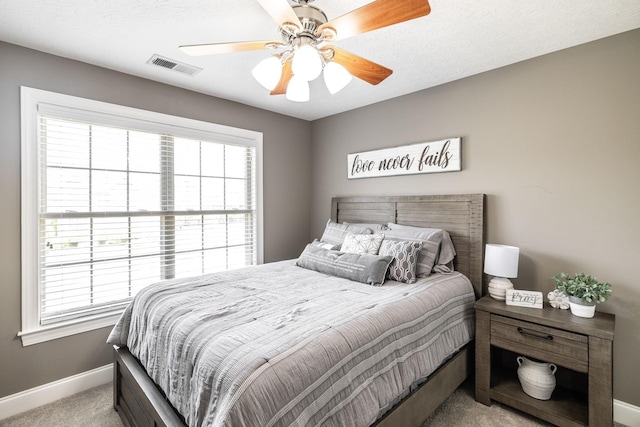 bedroom featuring baseboards, multiple windows, light carpet, and visible vents