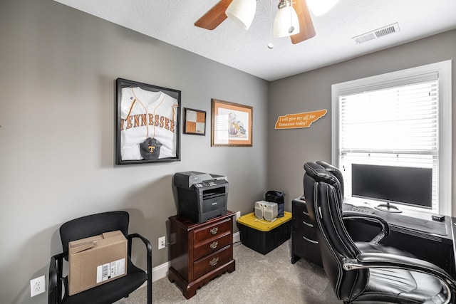 home office featuring baseboards, carpet, a ceiling fan, and visible vents