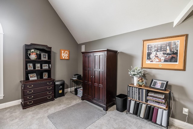 home office with baseboards, vaulted ceiling, and light colored carpet