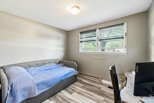 2608 Walnut Ln, Murfreesboro, TN 37129 - bedroom featuring a textured ceiling, wood finished floors, a baseboard heating unit, and baseboards
