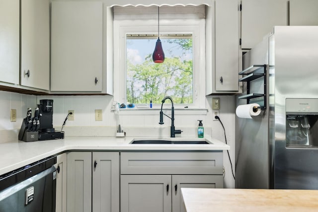 2608 Walnut Ln, Murfreesboro, TN 37129 - kitchen with light countertops, a sink, dishwashing machine, and stainless steel fridge with ice dispenser