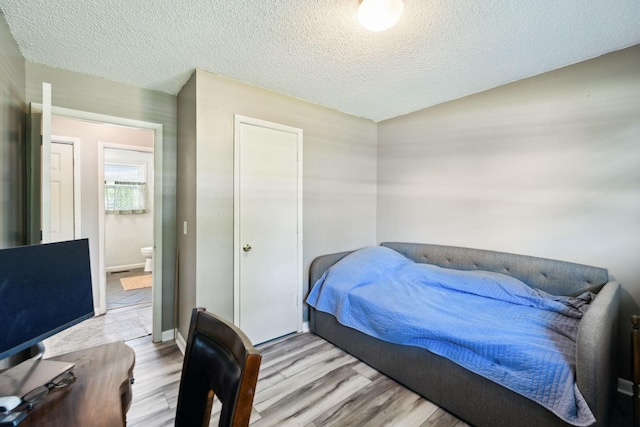 2608 Walnut Ln, Murfreesboro, TN 37129 - bedroom with a textured ceiling and light wood-style flooring