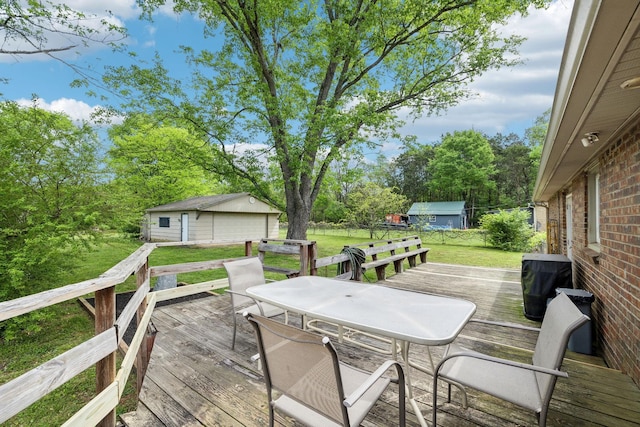 2608 Walnut Ln, Murfreesboro, TN 37129 - deck featuring an outbuilding, a lawn, outdoor dining area, and a detached garage