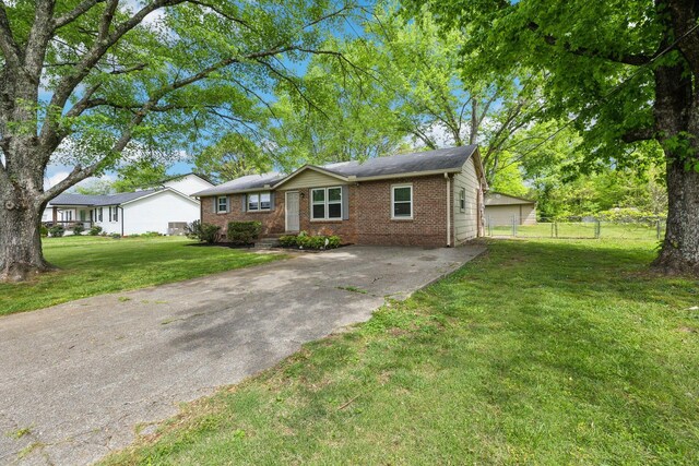 2608 Walnut Ln, Murfreesboro, TN 37129 - ranch-style home with brick siding, fence, a front lawn, and concrete driveway