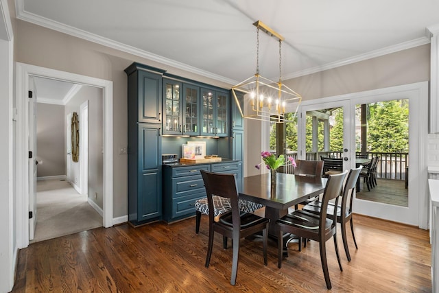 dining room with dark wood-style flooring, baseboards, a notable chandelier, french doors, and crown molding