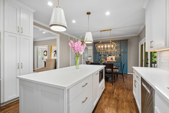 kitchen featuring built in microwave, an inviting chandelier, a center island, light countertops, and dishwasher