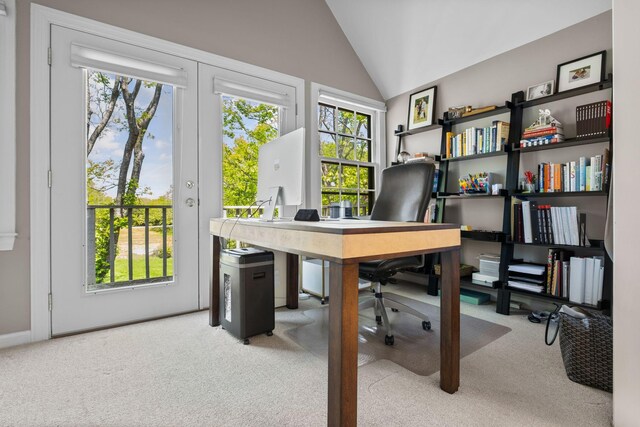 carpeted office featuring lofted ceiling