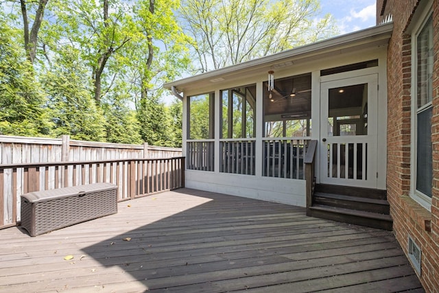 wooden terrace with fence and a sunroom