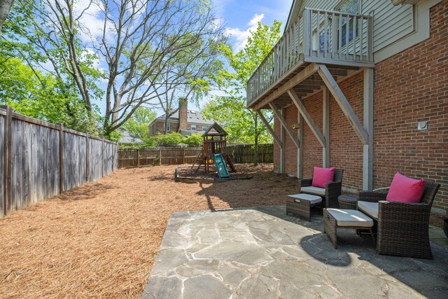 view of patio / terrace featuring a fenced backyard and a playground