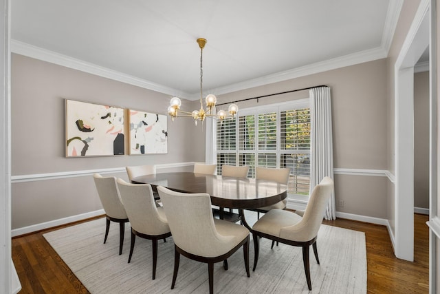 dining space featuring an inviting chandelier, wood finished floors, ornamental molding, and baseboards