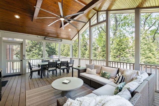 sunroom featuring a wealth of natural light, outdoor dining space, ceiling fan, and an outdoor hangout area