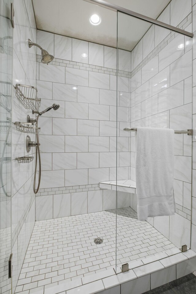 bathroom with a stall shower and recessed lighting