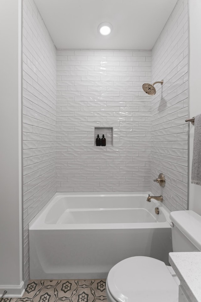 bathroom with tile patterned flooring, toilet, shower / washtub combination, and vanity