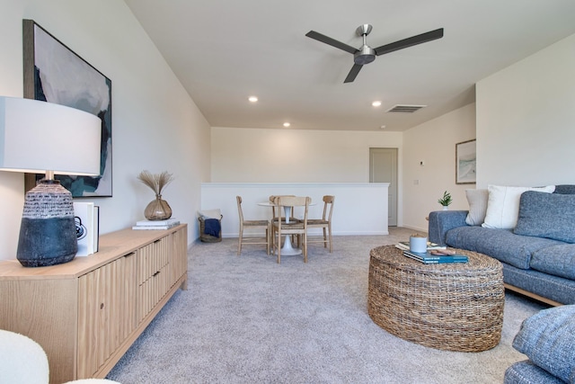 living room featuring recessed lighting, ceiling fan, visible vents, baseboards, and light colored carpet