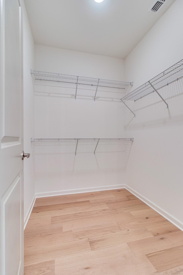 spacious closet with visible vents and light wood-style flooring