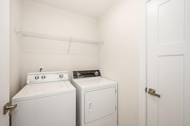 washroom featuring laundry area and washer and clothes dryer