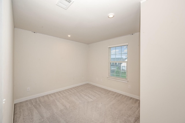 empty room with baseboards, carpet, recessed lighting, and visible vents