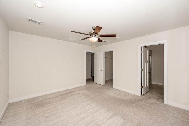 unfurnished bedroom with visible vents, carpet floors, baseboards, recessed lighting, and a spacious closet