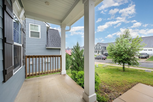 view of patio featuring covered porch and a residential view