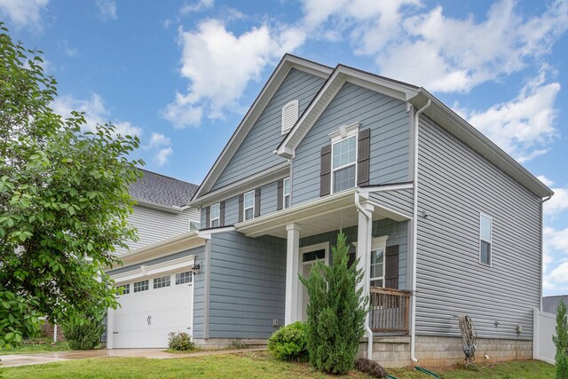 view of front of property featuring covered porch and concrete driveway