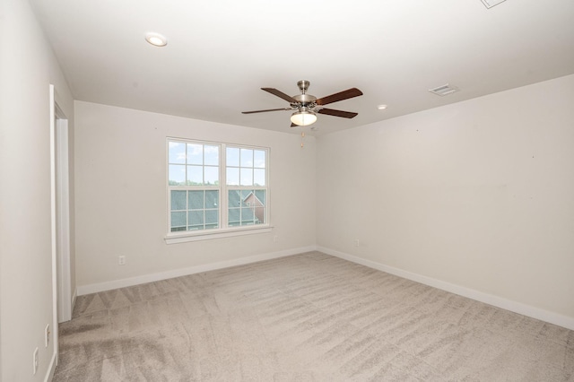 spare room with carpet flooring, a ceiling fan, baseboards, recessed lighting, and visible vents