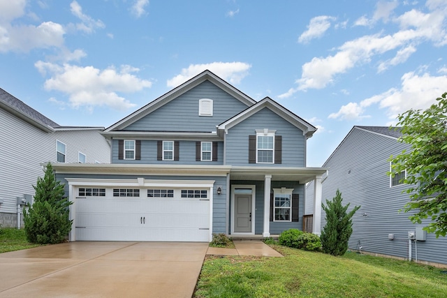 traditional-style house with an attached garage, a front lawn, driveway, and covered porch