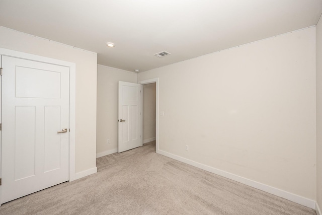 unfurnished bedroom featuring carpet floors, baseboards, and visible vents