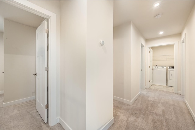 hallway with baseboards, light colored carpet, recessed lighting, and washing machine and clothes dryer