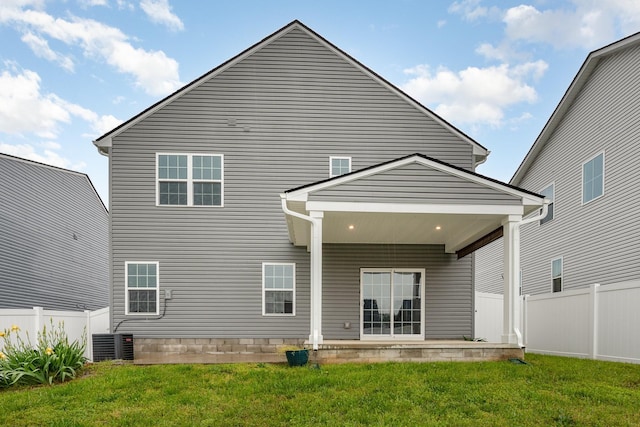 back of house with a yard, central AC, and fence