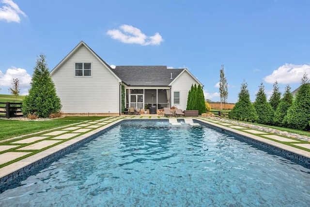 view of pool with a fenced in pool, a yard, outdoor lounge area, and a sunroom