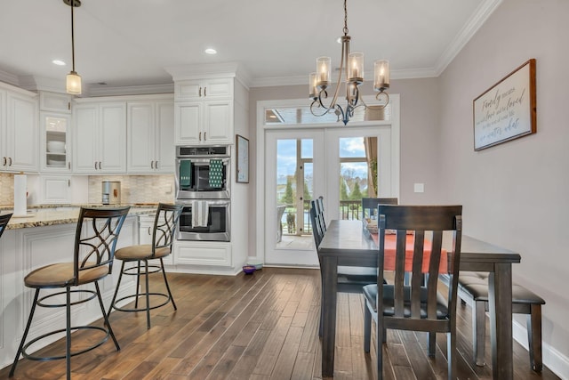 dining room featuring ornamental molding, baseboards, a notable chandelier, french doors, and dark wood-type flooring