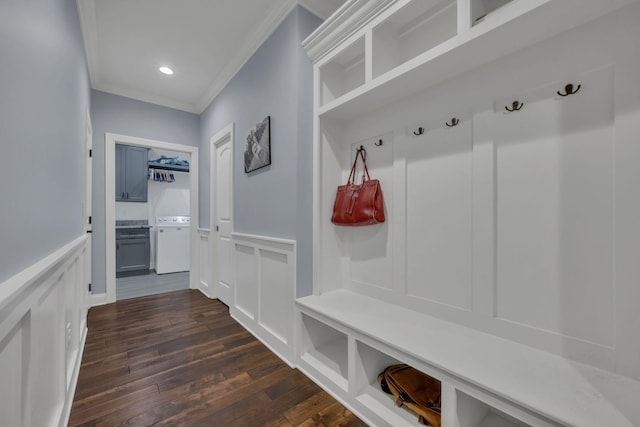 mudroom with dark wood-type flooring, a decorative wall, ornamental molding, and wainscoting