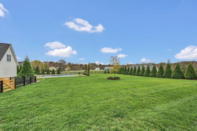 view of yard featuring a fenced in pool and fence