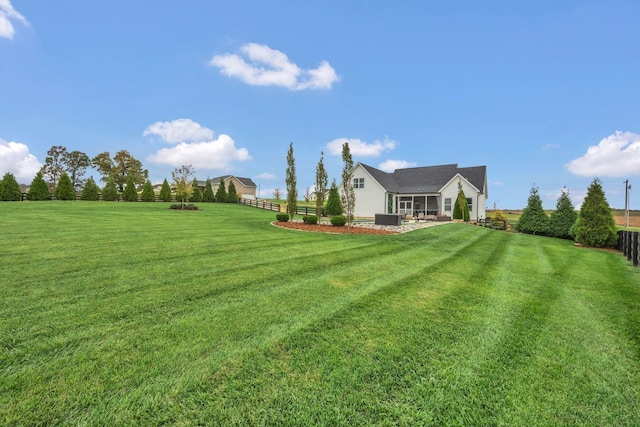 view of yard with a patio, a fenced backyard, and central air condition unit