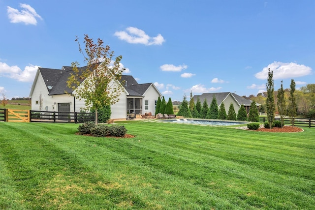 view of yard featuring fence and a sunroom