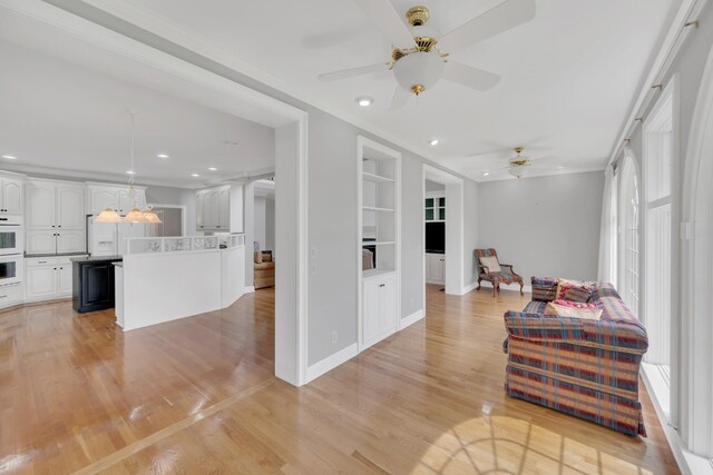 5112 Herschel Spears Cir, Brentwood, TN 37027 - living room featuring baseboards, a ceiling fan, built in features, and light wood-style flooring