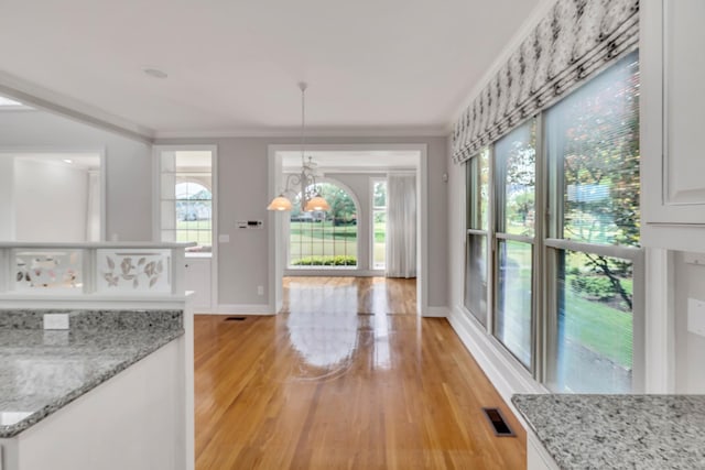 5112 Herschel Spears Cir, Brentwood, TN 37027 - unfurnished dining area with a notable chandelier, light wood-style floors, ornamental molding, and baseboards
