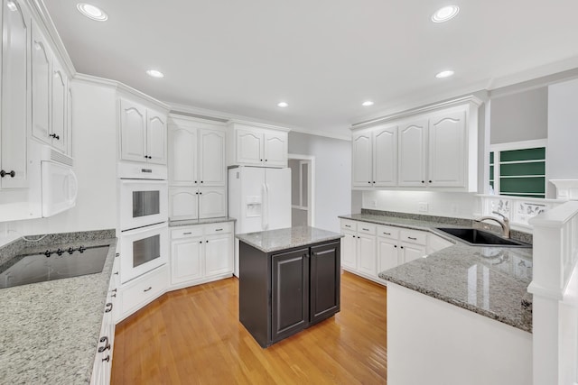 5112 Herschel Spears Cir, Brentwood, TN 37027 - kitchen featuring white cabinetry, white appliances, light wood finished floors, and a sink