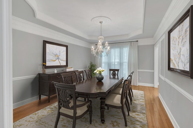 5112 Herschel Spears Cir, Brentwood, TN 37027 - dining area with an inviting chandelier, light wood-style flooring, a tray ceiling, and baseboards