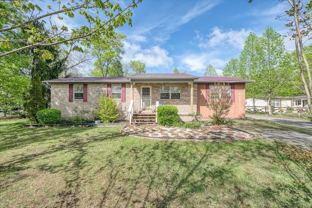 310 Woodlands Cir, Crossville, TN 38571 - single story home featuring a front lawn and brick siding