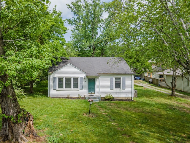 bungalow-style house featuring a front yard